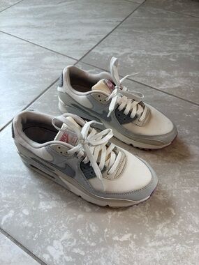 Nike air max white and light gray low-top sneakers with subtle pink accents